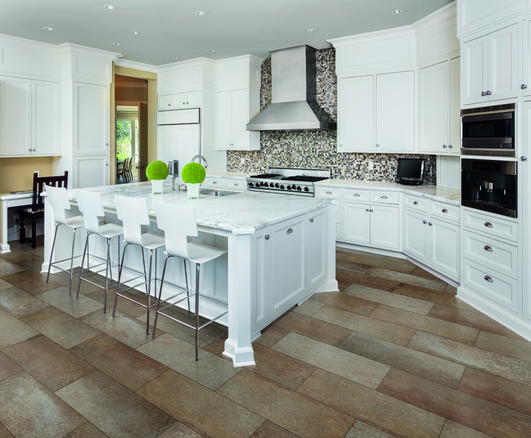 White kitchen with large center island and loads of crown molding