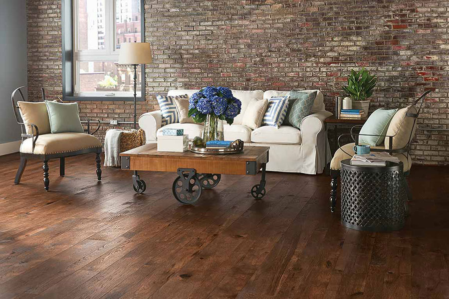 Living room that mixes styles with a conventional couch and a unique modern themed coffee table and chairs.