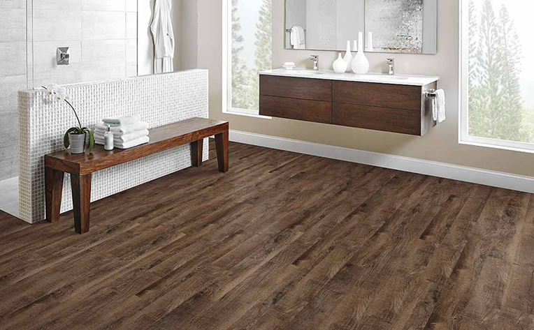 Large bathroom with dark hardwood flooring and floating style sink